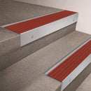Satin Aluminium finish 66x55mm raked back aluminium stair nosing with a Rustic Castellated insert, fitted to interior steps