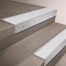Satin Aluminium finish 66x55mm raked back aluminium stair nosing with a White Castellated insert, fitted to interior steps