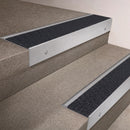 Satin Aluminium finish 66x55mm raked back aluminium stair nosing with a Black Olympic Grip insert, fitted to interior steps
