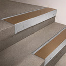 Satin Aluminium finish 66x55mm raked back aluminium stair nosing with a Bronze Aluminium insert, fitted to interior steps