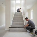 Aluminium stair nosing with putty coloured anti-slip insert on light grey porcelain tiled staircase Scandinavian interior