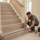 Aluminium stair nosing with rich brown anti-slip insert on terracotta sandstone tiled staircase traditional UK hallway