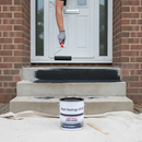 Black anti-slip step paint being rolled onto concrete steps for a bold, high-contrast finish
