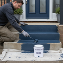 Dark blue anti-slip step paint being applied to concrete steps outside a home
