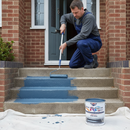 Mid blue anti-slip step paint being rolled onto a front doorstep