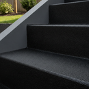 Black FootGrip anti-slip step paint applied to concrete steps, modern rendered house steps with a sleek grey render wall