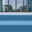 Mid Blue FootGrip anti-slip step paint applied to concrete steps, office building entrance steps with glass doors behind