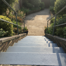 Mid Grey FootGrip anti-slip step paint applied to concrete steps, garden steps leading down to a paved patio