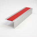 Square-edge aluminium stair nosing with a 56mm deep front face and a single red anti-slip insert, mill finish, on a plain studio background