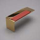 Square-edge aluminium stair nosing in a Mirrorflect Gold mirror finish with a red anti-slip insert, on a plain studio background