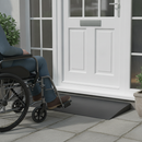 Black rubber threshold ramp in use at a UK front door with a wheelchair