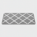 Grey diamond-pattern self-adhesive carpet stair tread pad, studio product shot