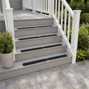 Black anti-slip treadplates on four pale grey porch steps with a white handrail and clipped shrub in a pot