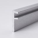 Cut end of an aluminium landing edge angle trim showing the L-shaped section and the stepped rebate for the floorcovering
