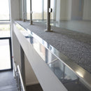 Bright polished aluminium landing edge angle trim capping the open edge of a carpeted office landing
