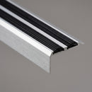 Close-up of the twin ribbed black rubber inserts seated in the anodised aluminium tread channels of the stair nosing