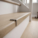uPVC wood effect stair nosing in Avero Oak fitted over a stair tread edge on a UK home staircase