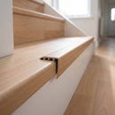 uPVC wood effect stair nosing in Beech fitted over a stair tread edge on a UK home staircase