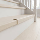 uPVC wood effect stair nosing in Country Oak fitted over a stair tread edge on a UK home staircase