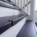 uPVC wood effect stair nosing in Dark Walnut fitted over a stair tread edge on a UK home staircase