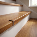 uPVC wood effect stair nosing in Gold Walnut fitted over a stair tread edge on a UK home staircase