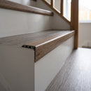 uPVC wood effect stair nosing in Smoked Oak fitted over a stair tread edge on a UK home staircase