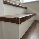 uPVC wood effect stair nosing in Walnut fitted over a stair tread edge on a UK home staircase