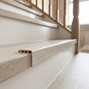 uPVC wood effect stair nosing in White Oak fitted over a stair tread edge on a UK home staircase
