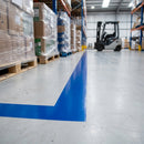 Blue vinyl line marking tape marking a staging area line on a warehouse floor beside palletised goods