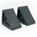 Pair of black rubber wheel chocks on a plain white studio background