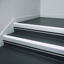 White Castellated insert in a 66x55mm square front aluminium stair nosing with 13mm black riser highlight, fitted to interior steps