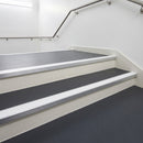 White PVC insert fitted in aluminium stair nosings on a hospital staircase
