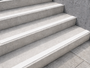White inserts running along the front edge of grey concrete steps, close angled view