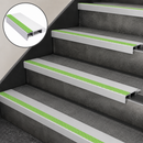 White and green slimline nosings on four dark grey steps, with an inset close-up of the profile