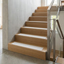 White inserts standing out against oak timber stair treads indoors