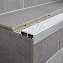Aluminium tile-in stair nosing with white anti-slip insert on grey tiled step