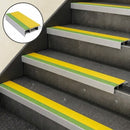 Yellow and green slimline nosings on four concrete steps, with an inset close-up of the profile