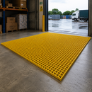 Yellow GRP anti-slip fibreglass floor grating panel in warehouse loading area