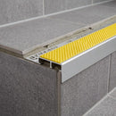 Aluminium tile-in stair nosing with yellow anti-slip insert on grey tiled step